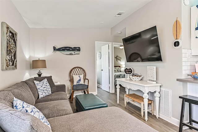 4126 Reeves Dr, Galveston, TX 77554 - living room featuring wood finished floors, ceiling fan, and baseboards