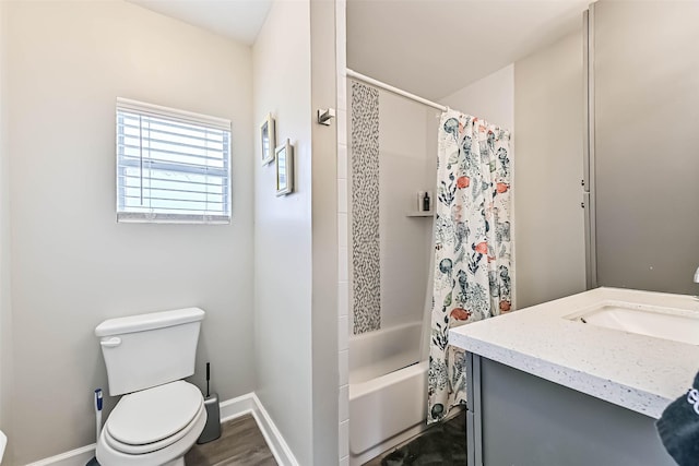 4126 Reeves Dr, Galveston, TX 77554 - full bathroom with toilet, baseboards, shower / tub combo with curtain, wood finished floors, and vanity