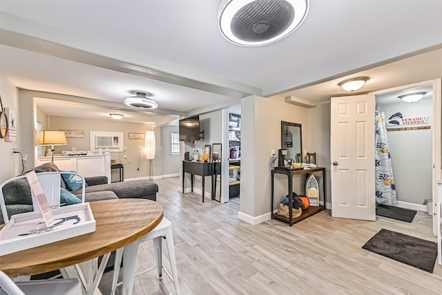 4126 Reeves Dr, Galveston, TX 77554 - dining space with light wood-style flooring and baseboards