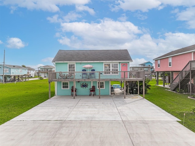 4126 Reeves Dr, Galveston, TX 77554 - view of front of home featuring stairs, concrete driveway, a front yard, and a wooden deck
