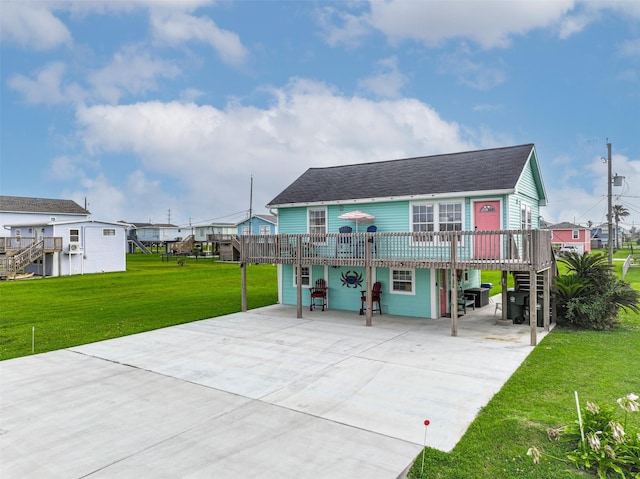 4126 Reeves Dr, Galveston, TX 77554 - back of house with driveway, a shingled roof, a lawn, and a deck