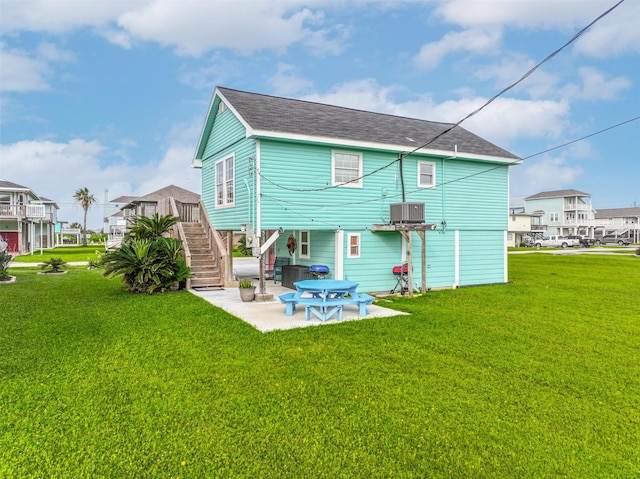 4126 Reeves Dr, Galveston, TX 77554 - rear view of property featuring stairs, a patio, a yard, and central air condition unit