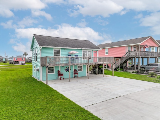 4126 Reeves Dr, Galveston, TX 77554 - back of property featuring a carport, a wooden deck, driveway, and a lawn