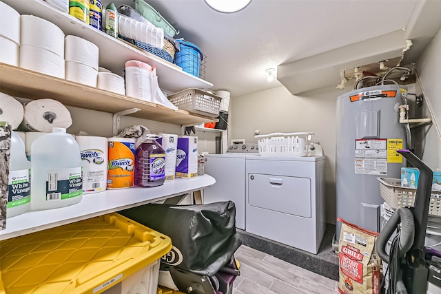 4126 Reeves Dr, Galveston, TX 77554 - washroom featuring water heater, washing machine and dryer, and wood finish floors