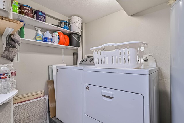 4126 Reeves Dr, Galveston, TX 77554 - laundry area with washer and clothes dryer and a textured ceiling