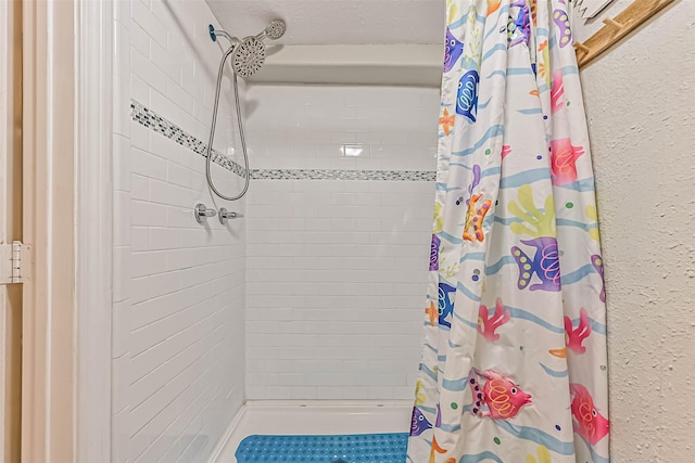 4126 Reeves Dr, Galveston, TX 77554 - bathroom with tiled shower and a textured wall