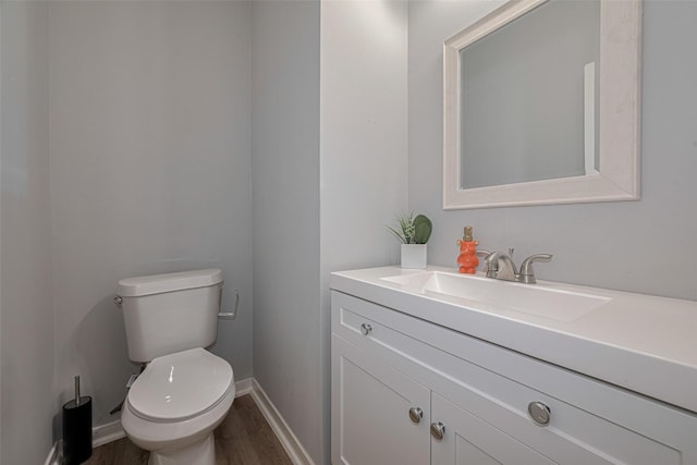 6718 Cleft Stone Dr, Houston, TX 77084 - half bath featuring wood finished floors, vanity, toilet, and baseboards