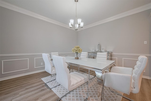 6718 Cleft Stone Dr, Houston, TX 77084 - dining room with a chandelier, wood finished floors, ornamental molding, wainscoting, and a decorative wall
