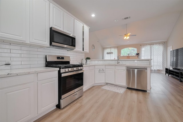 6718 Cleft Stone Dr, Houston, TX 77084 - kitchen featuring appliances with stainless steel finishes, a sink, a peninsula, light wood-style floors, and recessed lighting