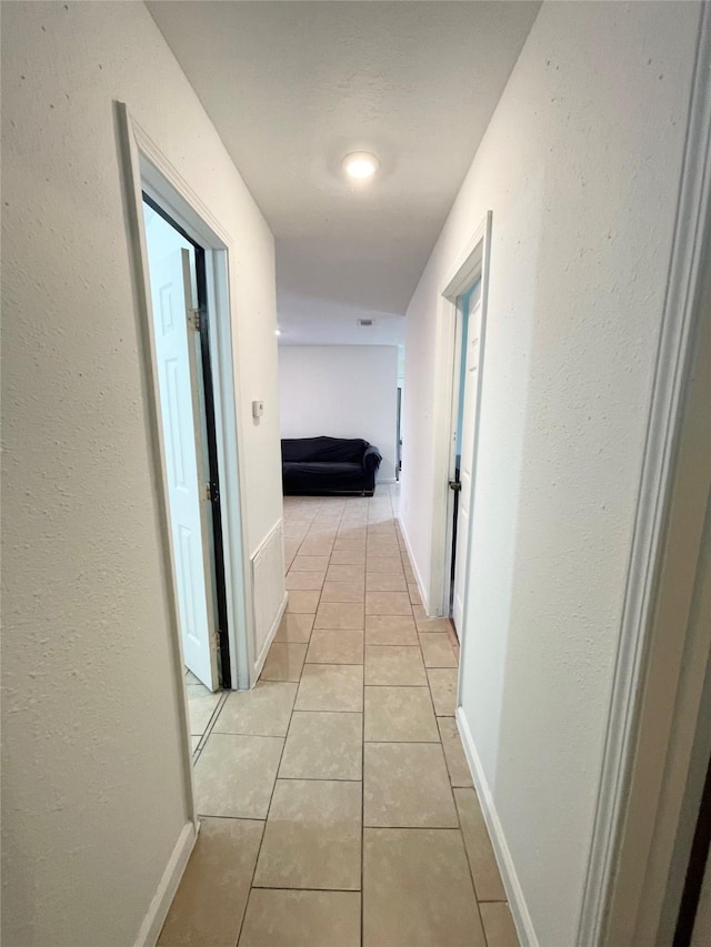 4118 Ebbtide Dr, Houston, TX 77045 - hallway with light tile patterned floors and baseboards