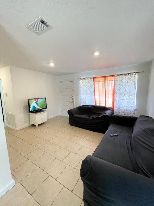 4118 Ebbtide Dr, Houston, TX 77045 - living room featuring light tile patterned floors, recessed lighting, and baseboards