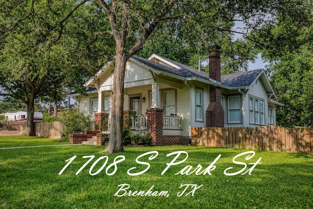 1708 S Park St, Brenham, TX 77833 - view of front of property featuring a chimney, a porch, and a shingled roof