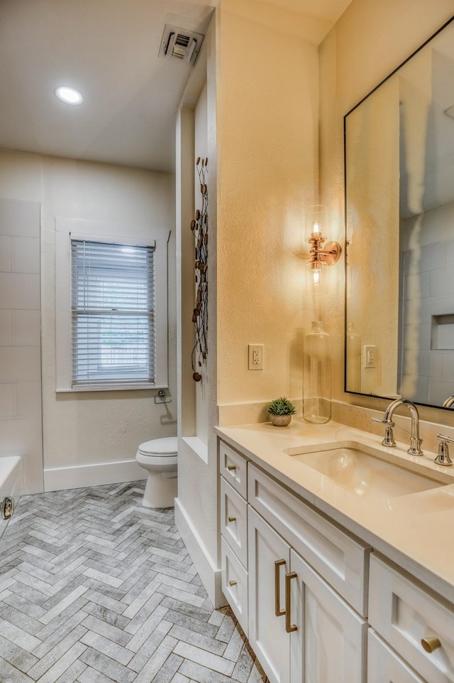 1708 S Park St, Brenham, TX 77833 - full bath featuring toilet, vanity, baseboards, brick patterned flooring, and recessed lighting