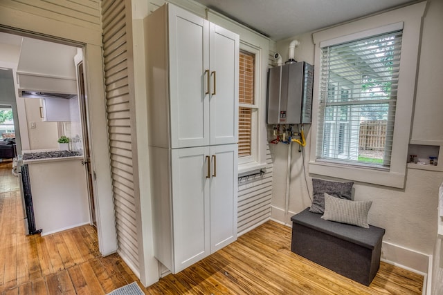 1708 S Park St, Brenham, TX 77833 - hall featuring water heater, light wood-type flooring, and baseboards