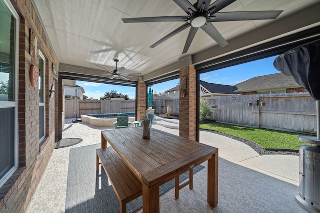 2517 Royal Terns Ct, League City, TX 77573 - fenced backyard with ceiling fan, a patio area, outdoor dining space, and a jacuzzi