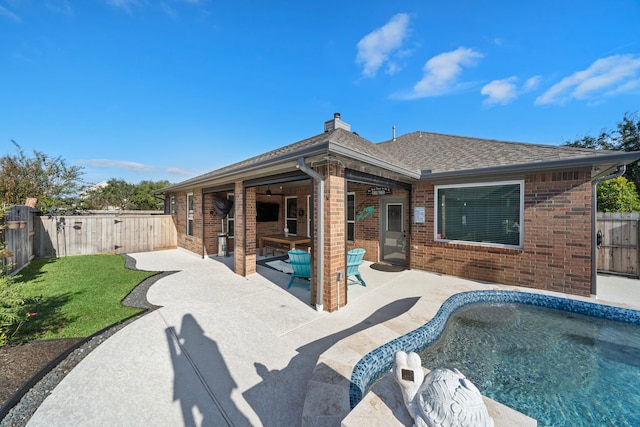 2517 Royal Terns Ct, League City, TX 77573 - rear view of house featuring brick siding, a patio, a chimney, and a shingled roof