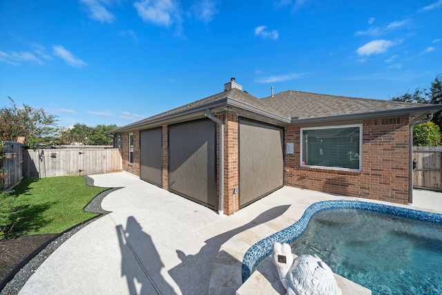 2517 Royal Terns Ct, League City, TX 77573 - back of property with a patio area, brick siding, a shingled roof, and a chimney