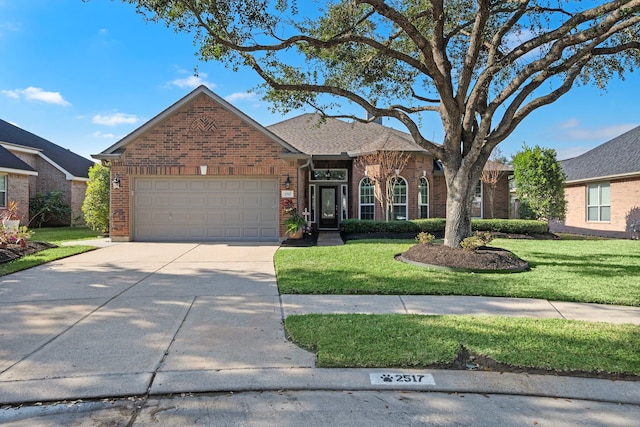 2517 Royal Terns Ct, League City, TX 77573 - view of front of property with brick siding, a front lawn, an attached garage, and driveway