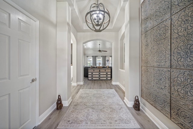 2517 Royal Terns Ct, League City, TX 77573 - corridor featuring arched walkways, wood finished floors, a chandelier, and baseboards
