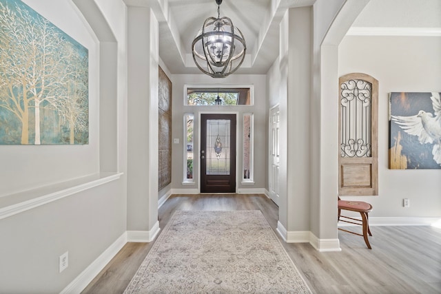 2517 Royal Terns Ct, League City, TX 77573 - entrance foyer with wood finished floors, a chandelier, baseboards, and arched walkways