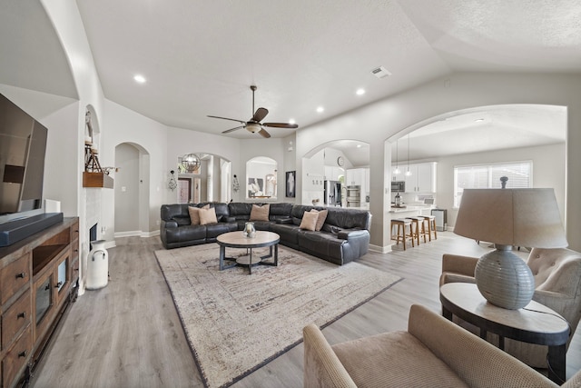 2517 Royal Terns Ct, League City, TX 77573 - living room with arched walkways, ceiling fan, lofted ceiling, light wood-type flooring, and recessed lighting