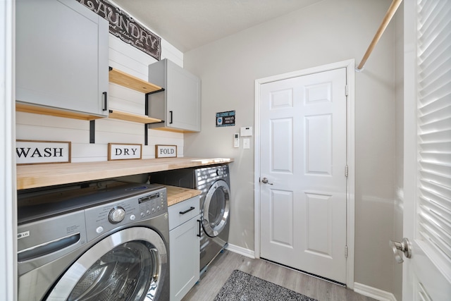 2517 Royal Terns Ct, League City, TX 77573 - washroom with cabinet space, separate washer and dryer, baseboards, and light wood-style flooring
