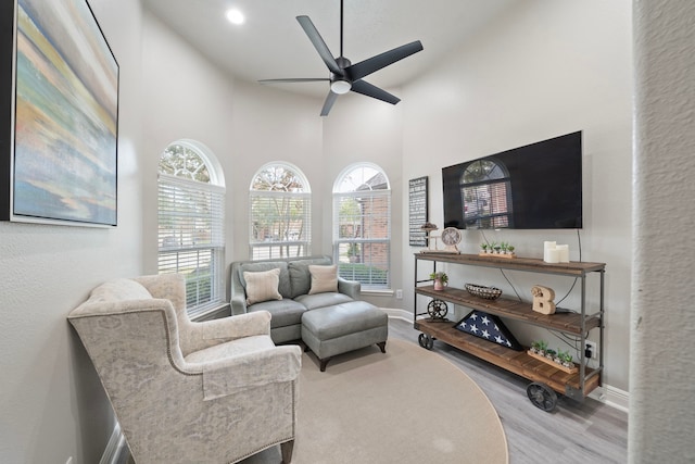 2517 Royal Terns Ct, League City, TX 77573 - living area with wood finished floors, a ceiling fan, baseboards, a towering ceiling, and recessed lighting