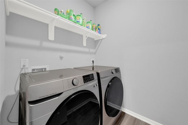 8835 Willet St, Baytown, TX 77521 - laundry area featuring washing machine and dryer and baseboards