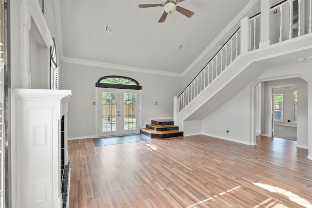 15034 Elstree Dr, Channelview, TX 77530 - unfurnished living room with french doors, ceiling fan, wood finished floors, stairway, and baseboards
