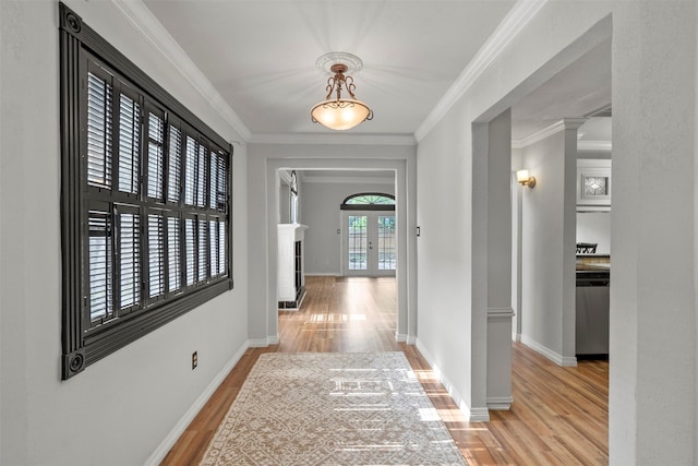15034 Elstree Dr, Channelview, TX 77530 - hall featuring light wood finished floors, baseboards, crown molding, french doors, and ornate columns
