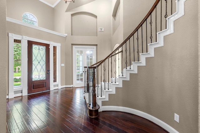 95 W Hullwood Cir, The Woodlands, TX 77389 - entrance foyer with healthy amount of natural light, baseboards, a towering ceiling, wood-type flooring, and stairs