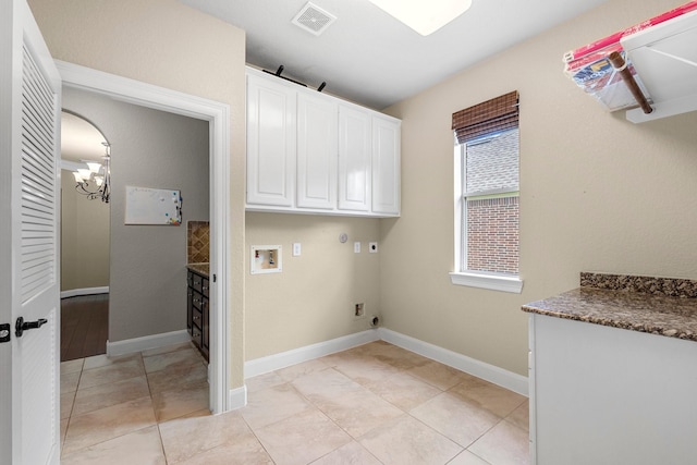 95 W Hullwood Cir, The Woodlands, TX 77389 - laundry area with hookup for an electric dryer, cabinet space, washer hookup, a chandelier, and baseboards