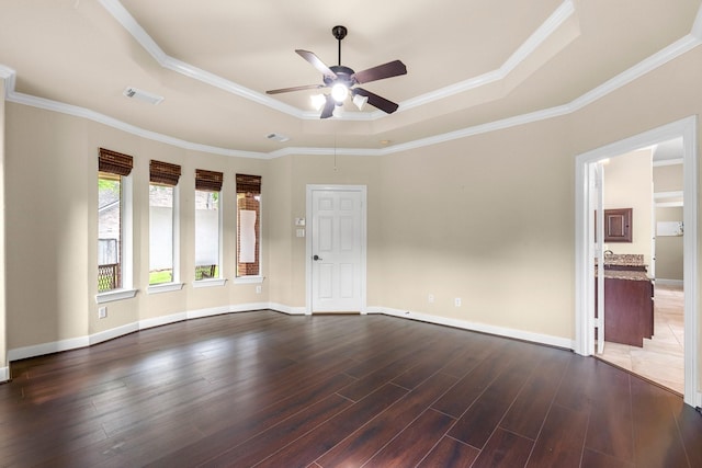 95 W Hullwood Cir, The Woodlands, TX 77389 - unfurnished room featuring a raised ceiling, ceiling fan, dark wood-style floors, baseboards, and crown molding
