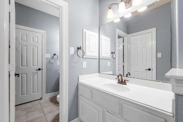 95 W Hullwood Cir, The Woodlands, TX 77389 - bathroom featuring toilet, tile patterned flooring, vanity, and a textured wall