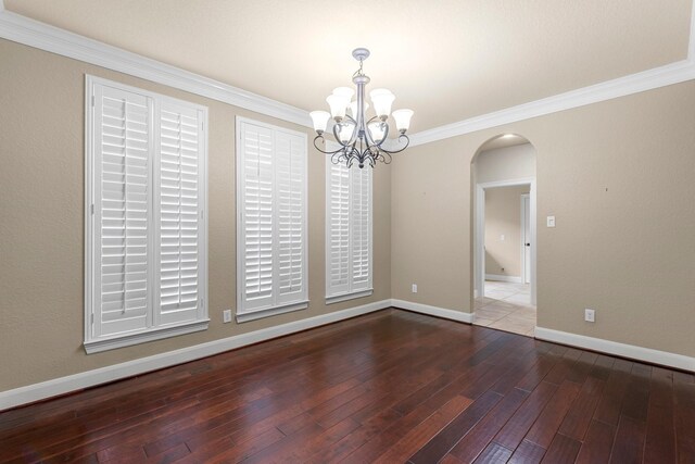 95 W Hullwood Cir, The Woodlands, TX 77389 - spare room featuring arched walkways, a chandelier, crown molding, baseboards, and hardwood / wood-style flooring