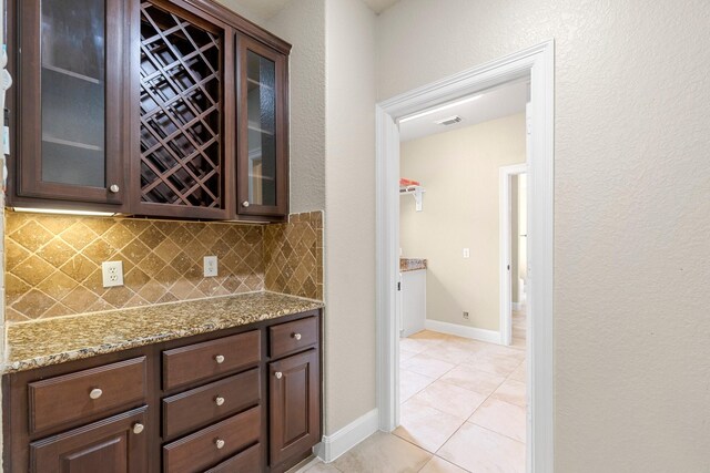 95 W Hullwood Cir, The Woodlands, TX 77389 - bar area featuring tasteful backsplash, light tile patterned floors, and baseboards