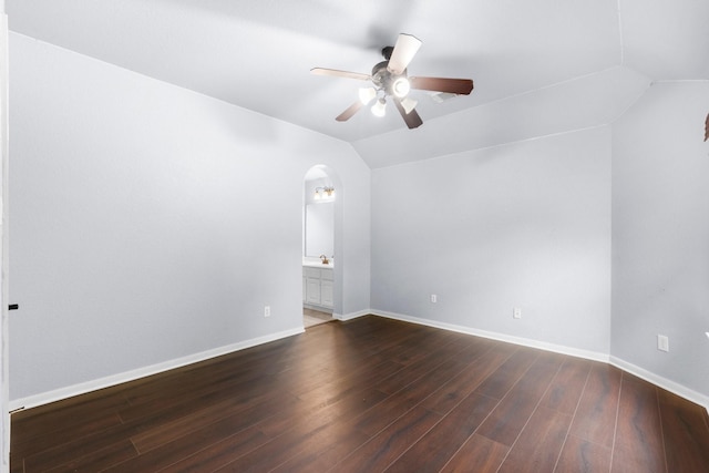 95 W Hullwood Cir, The Woodlands, TX 77389 - spare room featuring vaulted ceiling, ceiling fan, arched walkways, dark wood-style flooring, and baseboards