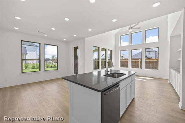 27007 Golden Isle Ln, Katy, TX 77493 - kitchen featuring a sink, open floor plan, recessed lighting, dishwasher, and light wood-style floors