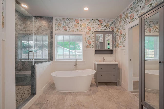 8302 Magna St, Houston, TX 77093 - bathroom featuring a stall shower, wainscoting, a soaking tub, vanity, and recessed lighting