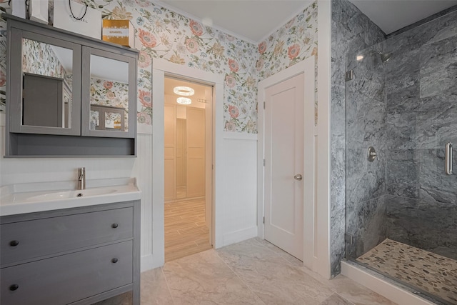 8302 Magna St, Houston, TX 77093 - bathroom with a shower stall, vanity, wallpapered walls, and a wainscoted wall