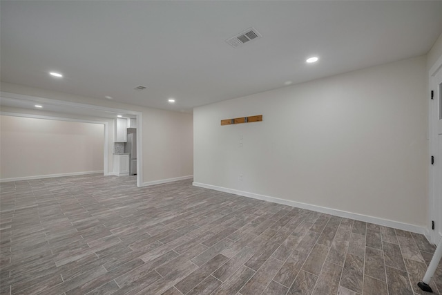 8302 Magna St, Houston, TX 77093 - finished below grade area with freestanding refrigerator, wood finished floors, baseboards, and recessed lighting