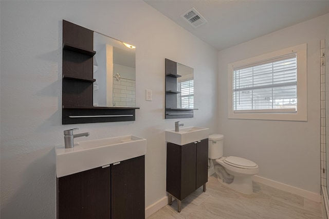 8302 Magna St, Houston, TX 77093 - full bathroom with toilet, baseboards, two vanities, a shower, and marble finish flooring