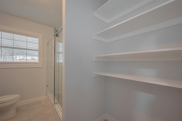 8302 Magna St, Houston, TX 77093 - full bath featuring a stall shower, toilet, and baseboards
