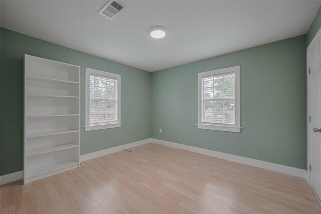 8302 Magna St, Houston, TX 77093 - unfurnished bedroom featuring light wood-type flooring and baseboards