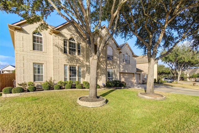 21714 Honeysuckle Grove Ln, Richmond, TX 77469 - view of front of home with driveway, a garage, and brick siding