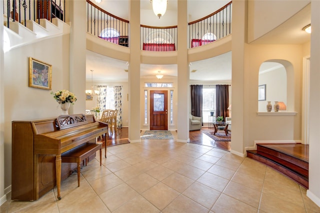 21714 Honeysuckle Grove Ln, Richmond, TX 77469 - entrance foyer featuring light tile patterned floors, baseboards, a chandelier, and a high ceiling