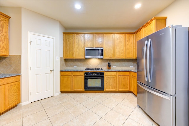 21714 Honeysuckle Grove Ln, Richmond, TX 77469 - kitchen featuring appliances with stainless steel finishes, backsplash, dark stone counters, light tile patterned floors, and recessed lighting
