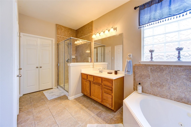 21714 Honeysuckle Grove Ln, Richmond, TX 77469 - full bathroom featuring vanity, a shower stall, a jetted tub, and tile patterned floors