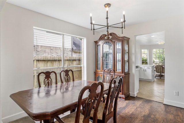 14531 County Cress Dr, Houston, TX 77047 - dining space with a chandelier, dark wood-style flooring, and baseboards