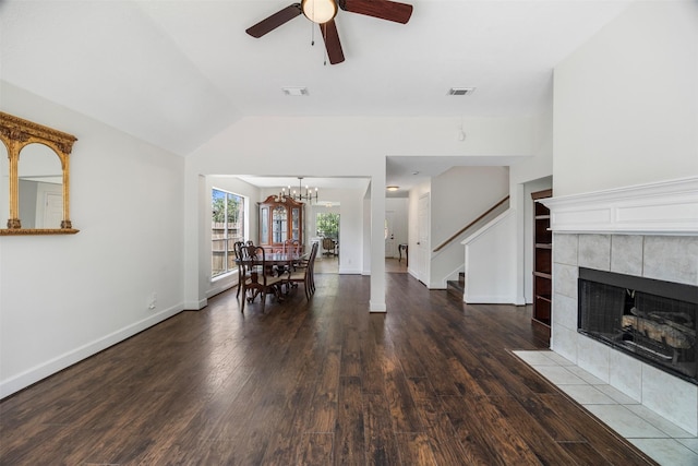 14531 County Cress Dr, Houston, TX 77047 - living area with wood finished floors, ceiling fan, stairway, a tiled fireplace, and a chandelier
